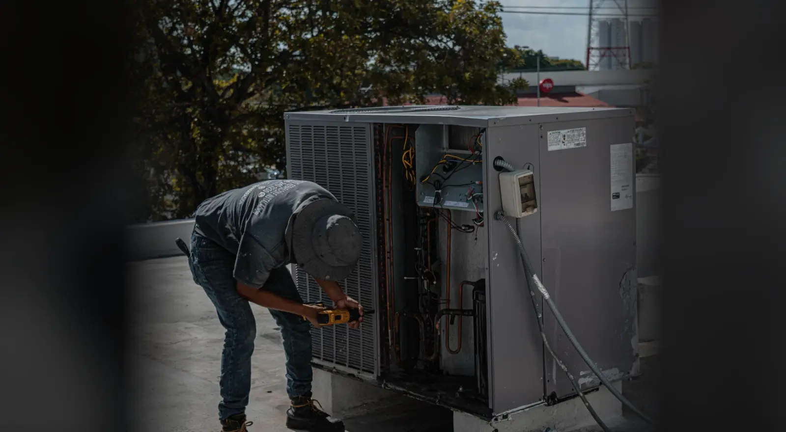 Técnico da House Service Ville em manutenção preventiva de uma condensadora de ar condicionado comercial